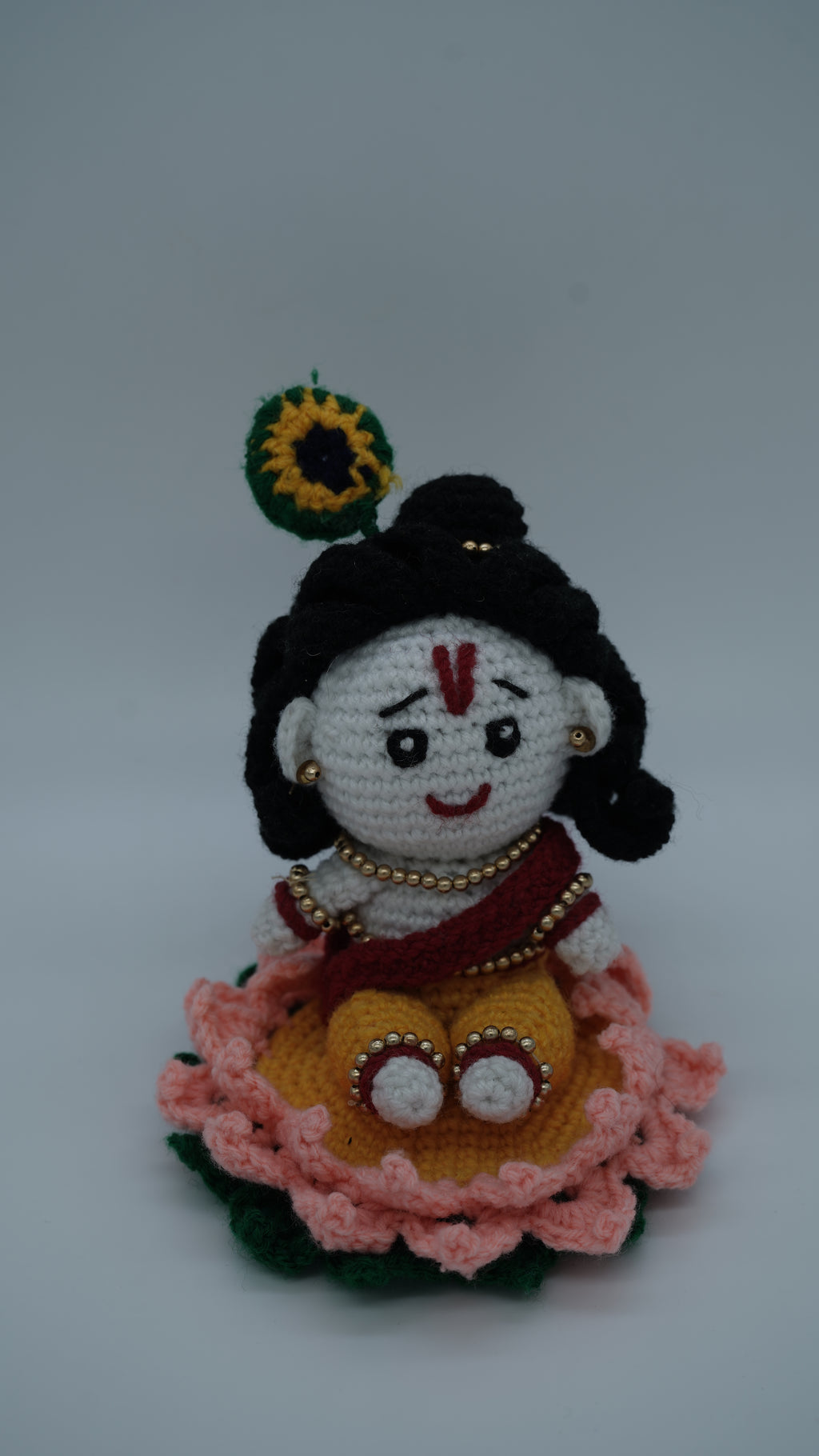Handmade Crochet Laddu Gopal Ji Idol with Decorative Beads and Lotus Base