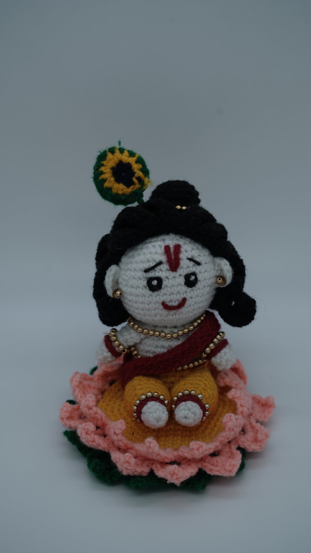 Handmade Crochet Laddu Gopal Ji Idol with Decorative Beads and Lotus Base