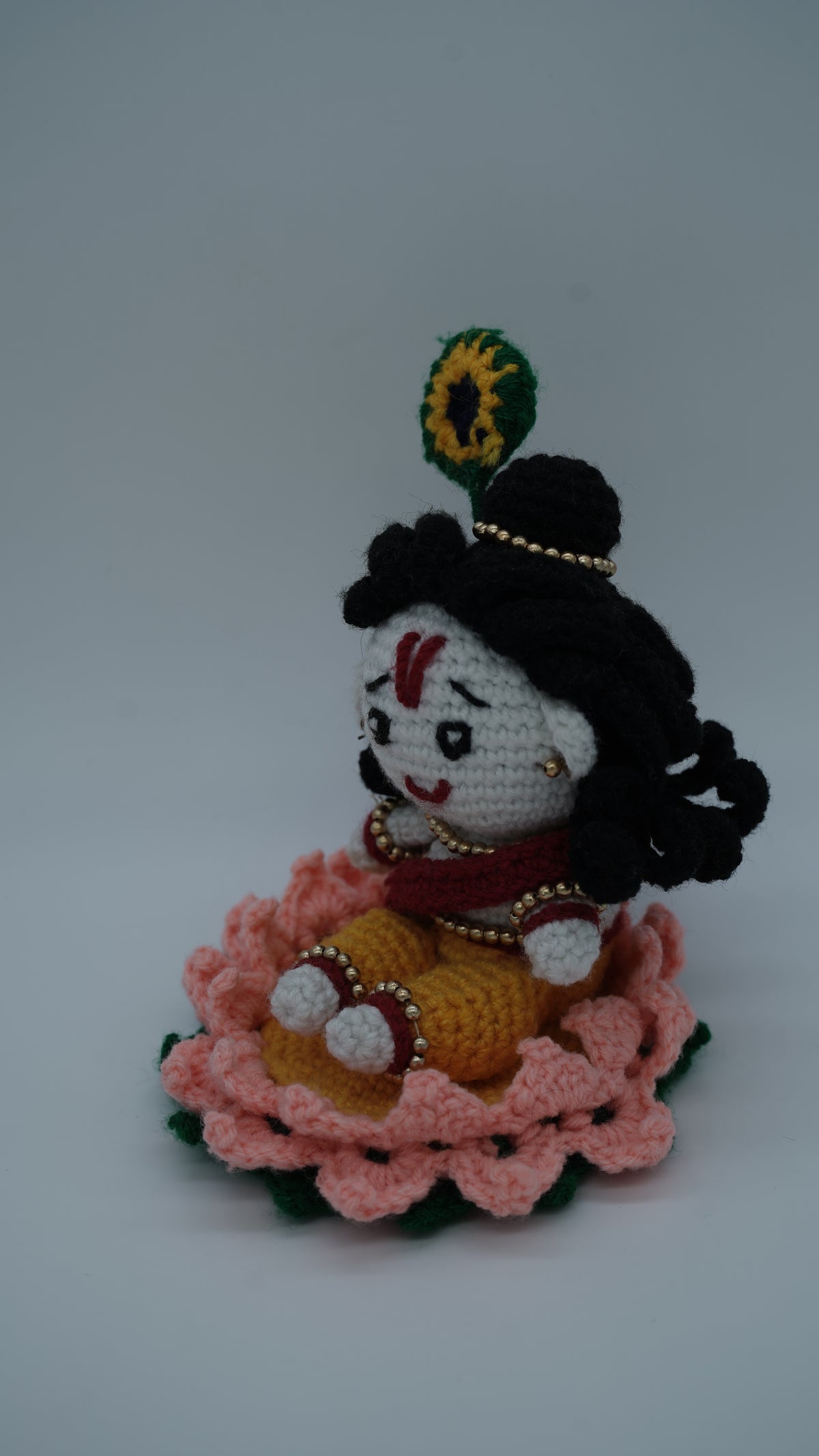 Handmade Crochet Laddu Gopal Ji Idol with Decorative Beads and Lotus Base