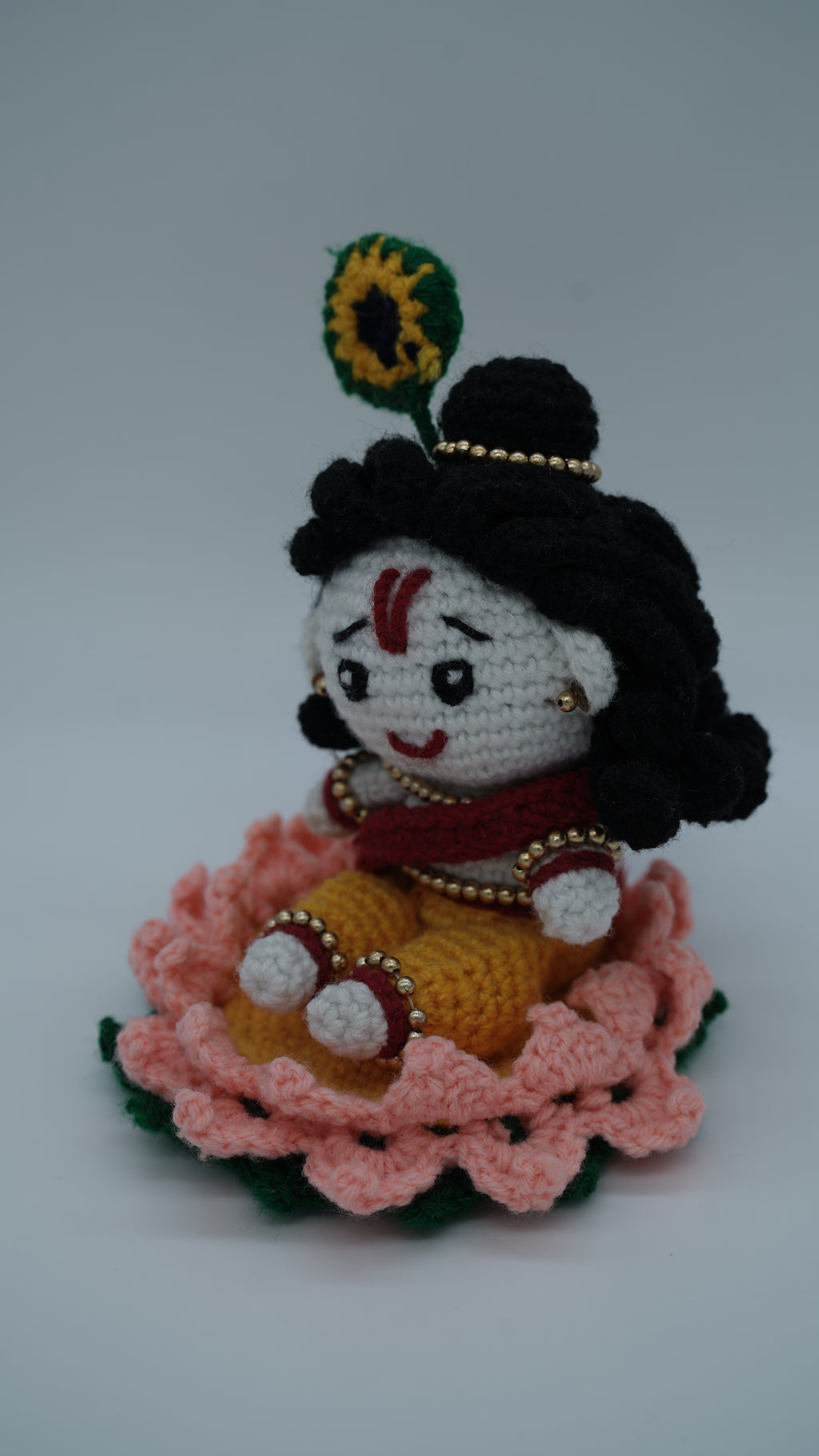 Handmade Crochet Laddu Gopal Ji Idol with Decorative Beads and Lotus Base