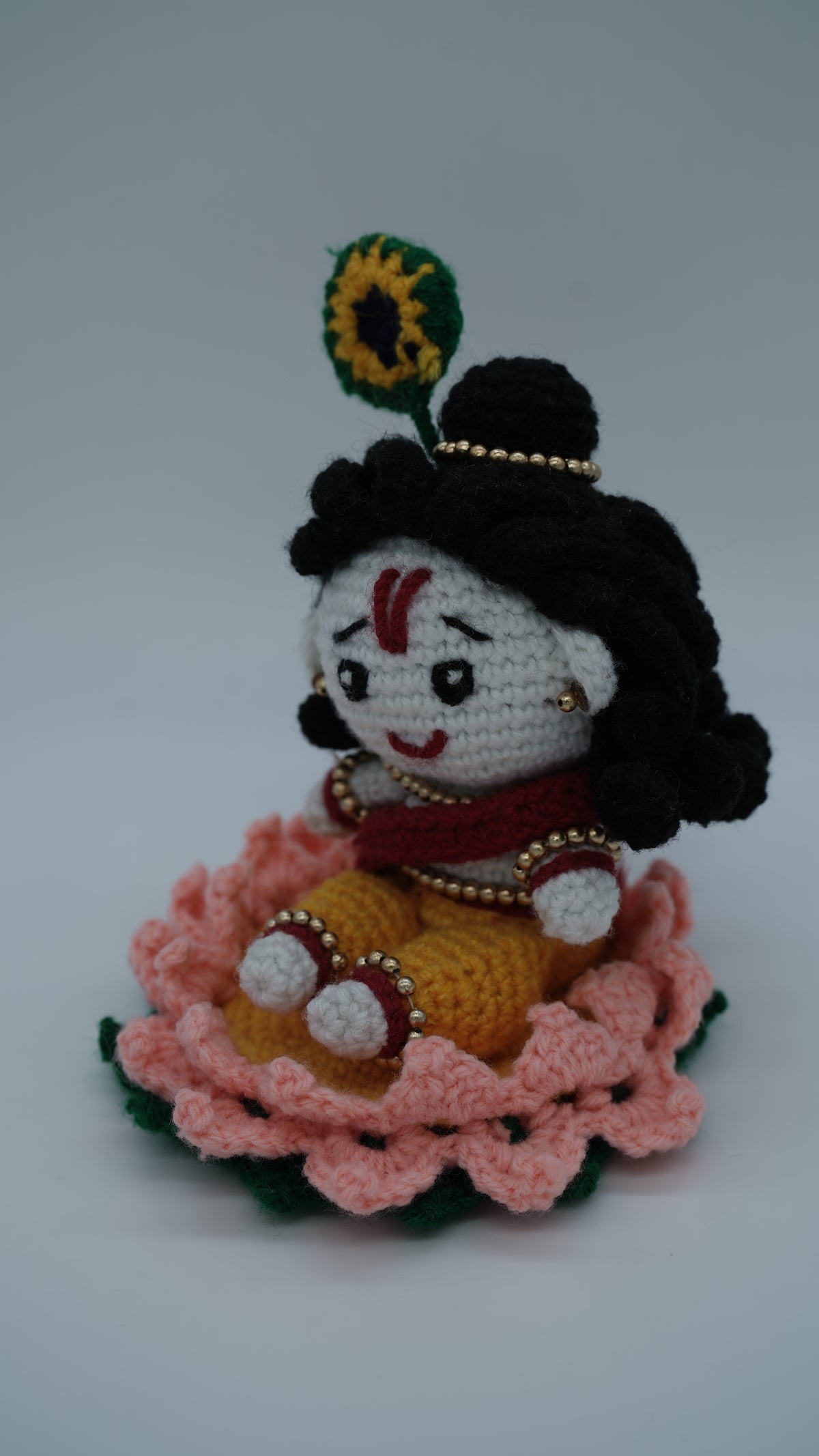 Handmade Crochet Laddu Gopal Ji Idol with Decorative Beads and Lotus Base